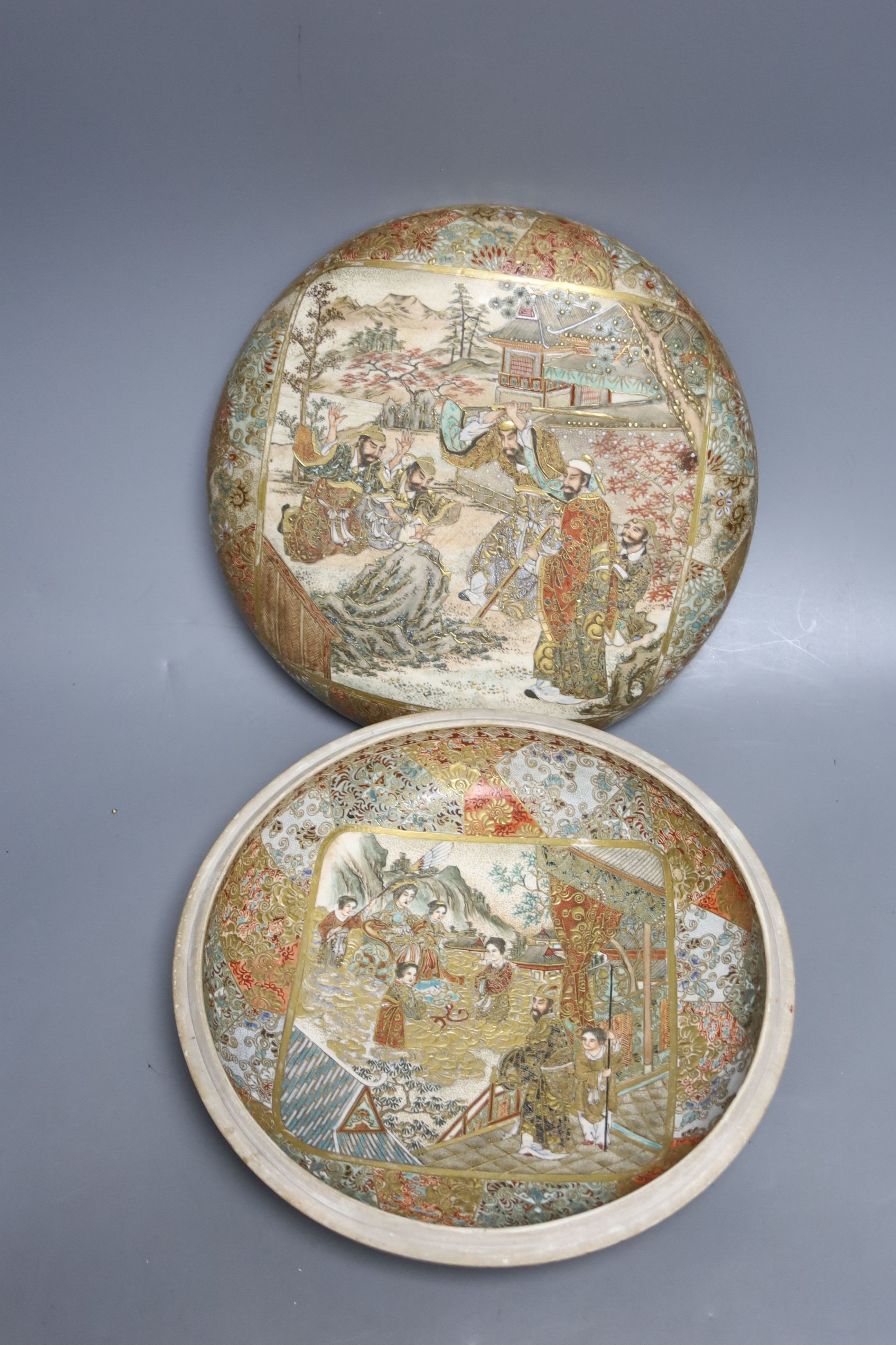 A late 19th century Japanese Satsuma box and cover, painted and gilded throughout, 23cm diameter